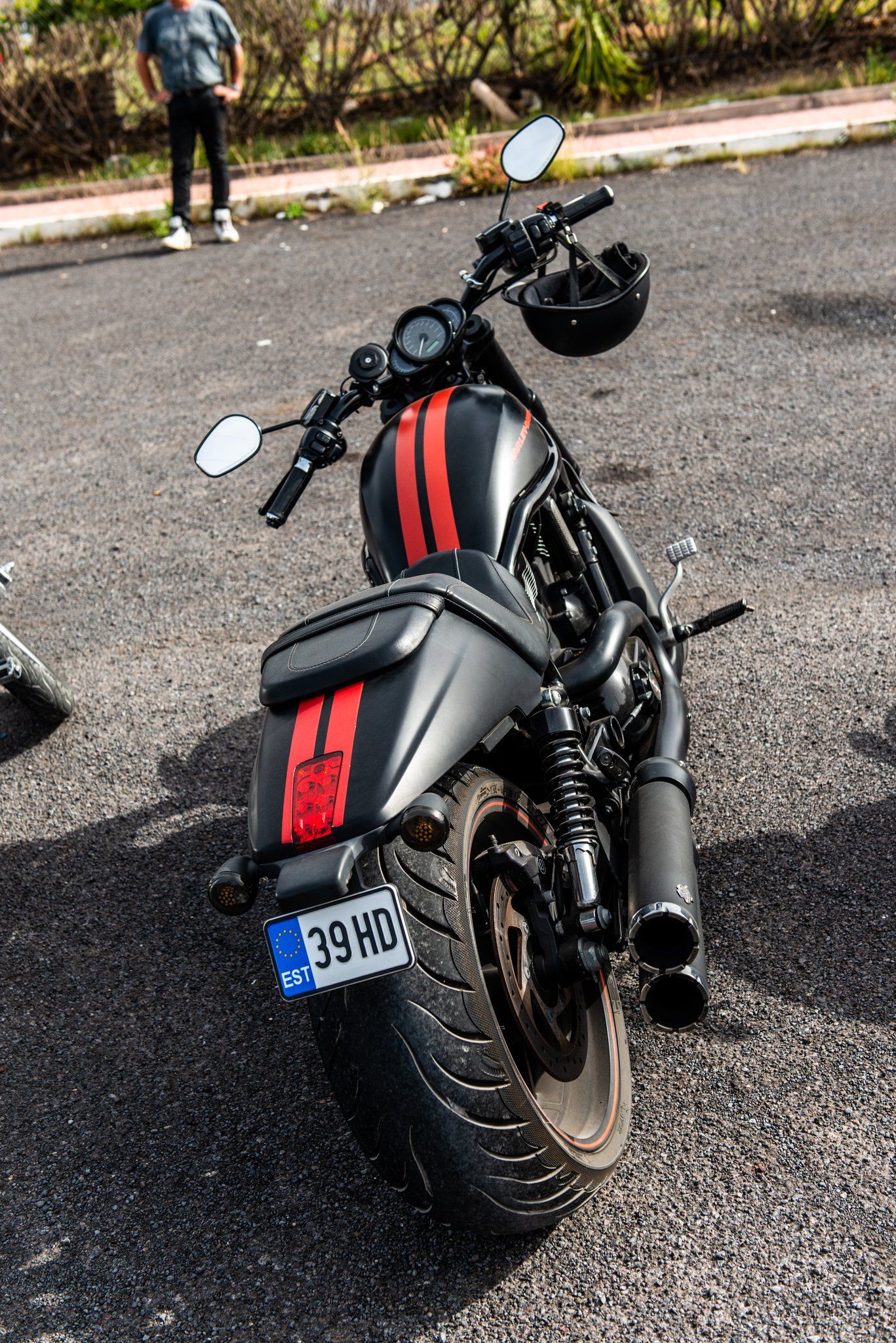 A black and red motorcycle is parked on the side of the road.