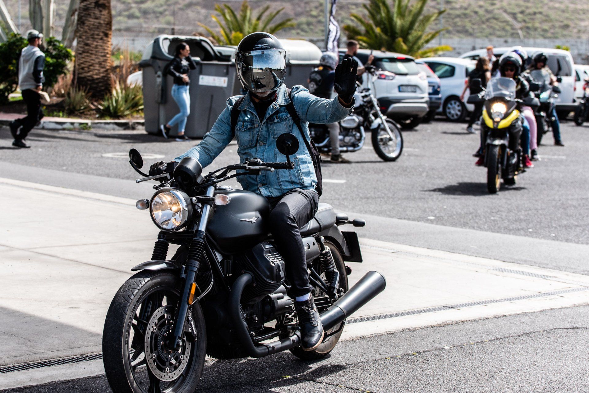 A group of people are riding motorcycles down a street.