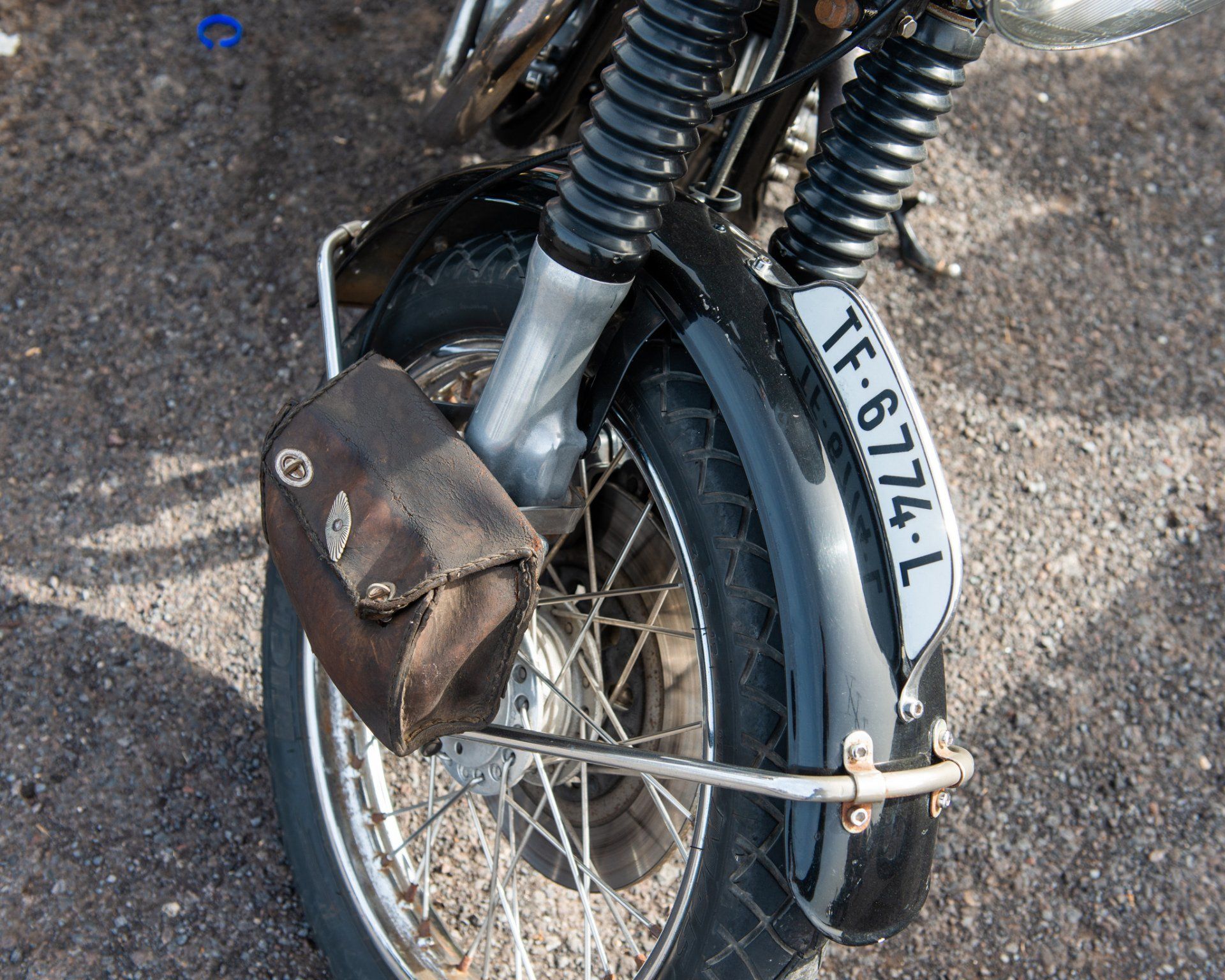 A motorcycle with a license plate that says tf 6774 l