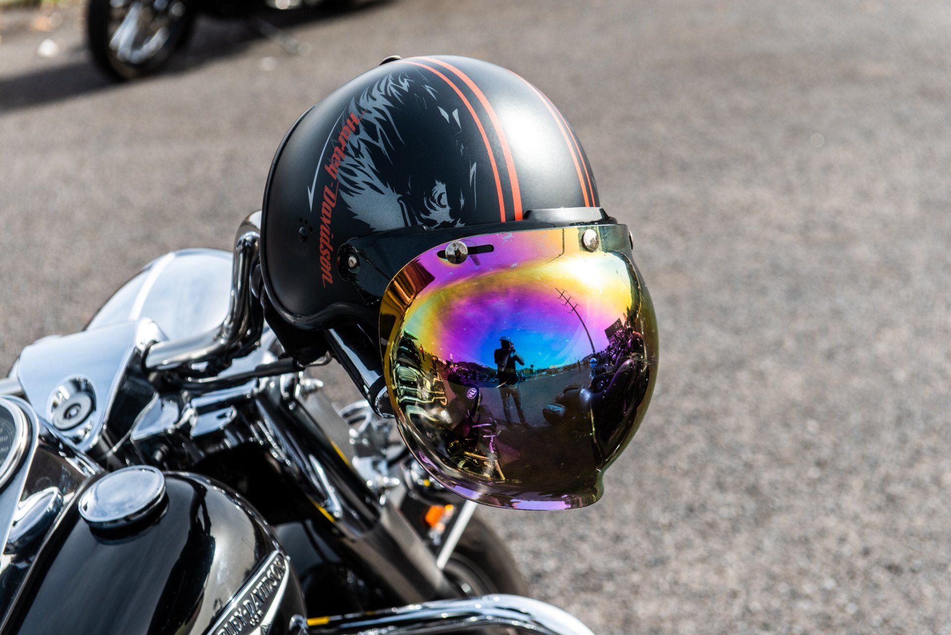 A close up of a motorcycle helmet with a rainbow visor
