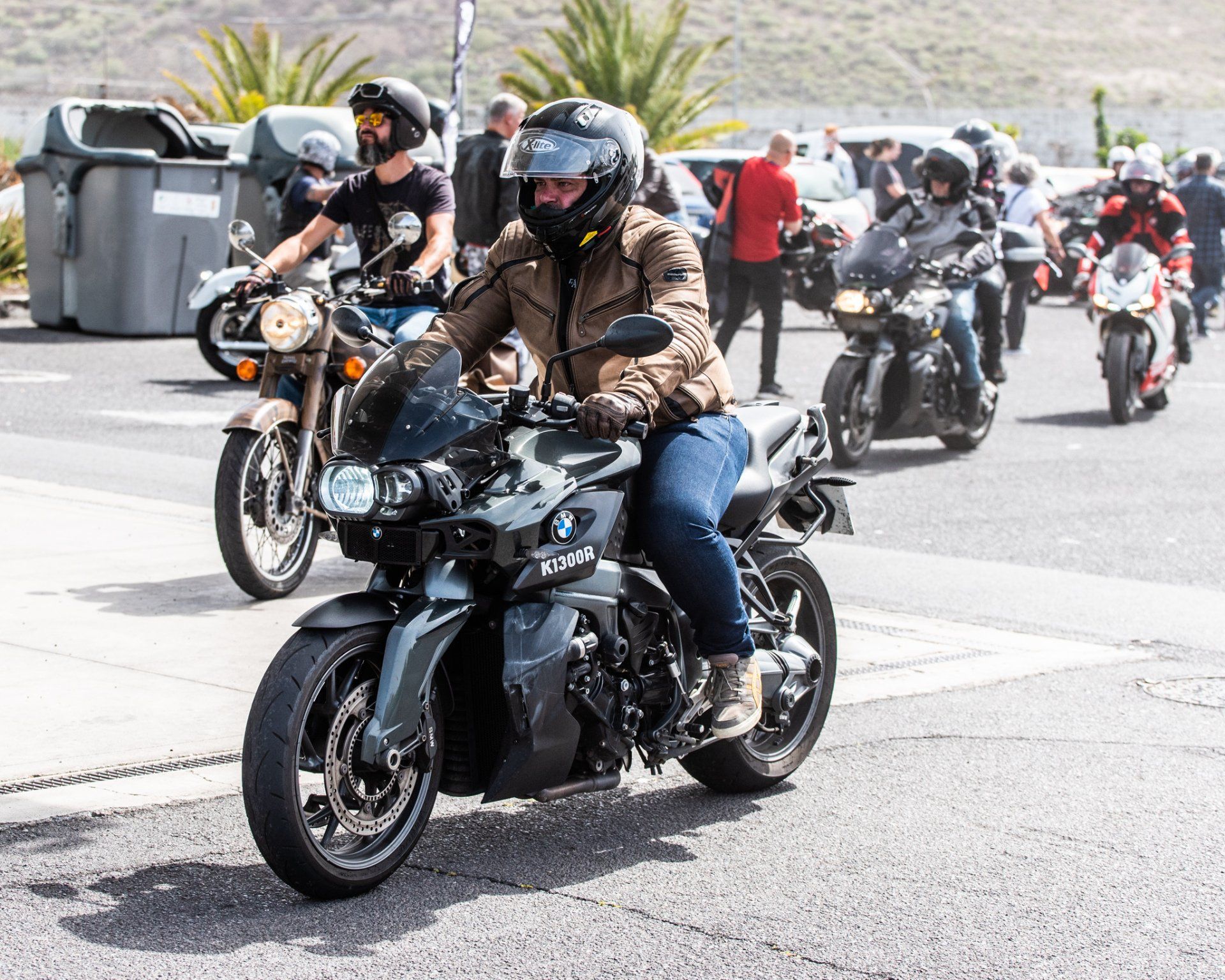 A group of people are riding motorcycles down a street.