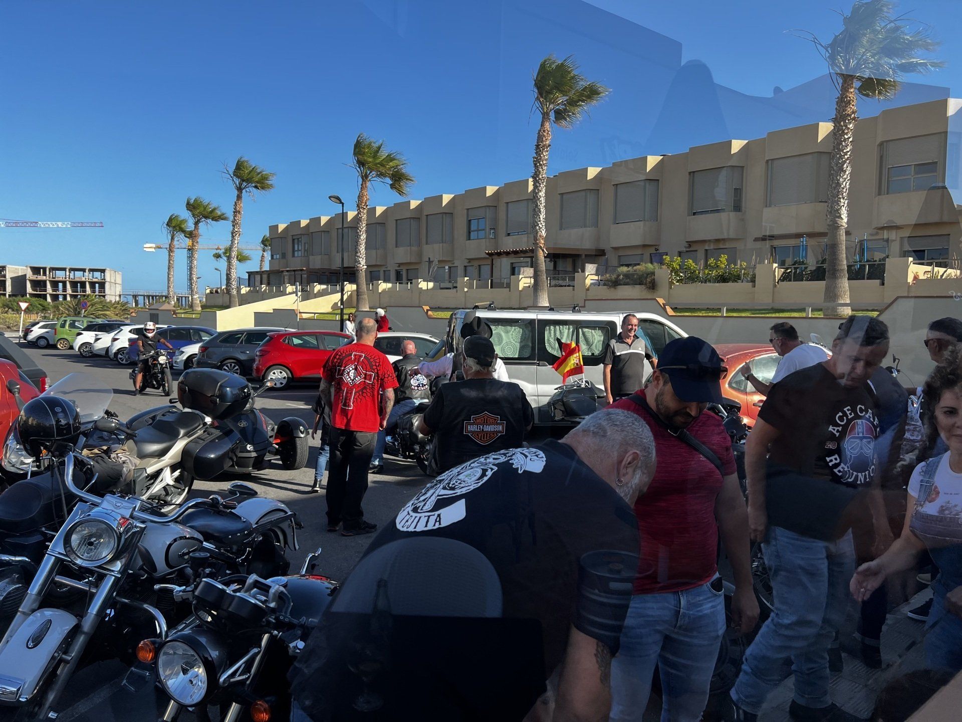 A group of people are gathered around a motorcycle with the number 7 on it