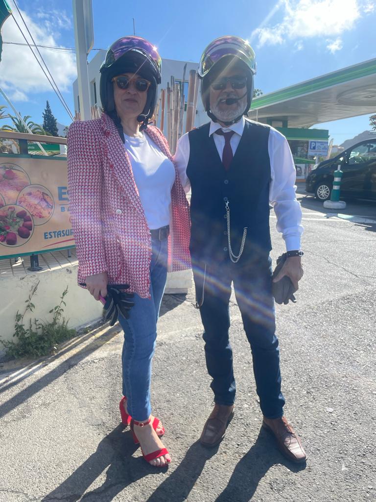 A man and a woman are standing next to each other on the side of the road.