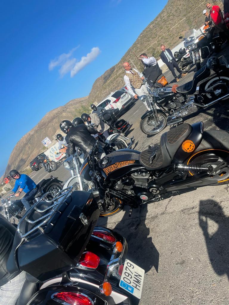 A group of motorcycles are parked on the side of the road.