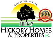 A logo for hickory homes and properties inc.