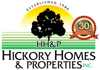 A logo for hickory homes and properties inc.