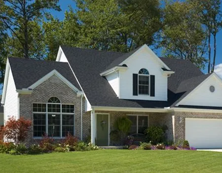 A white house with a black roof and black shutters