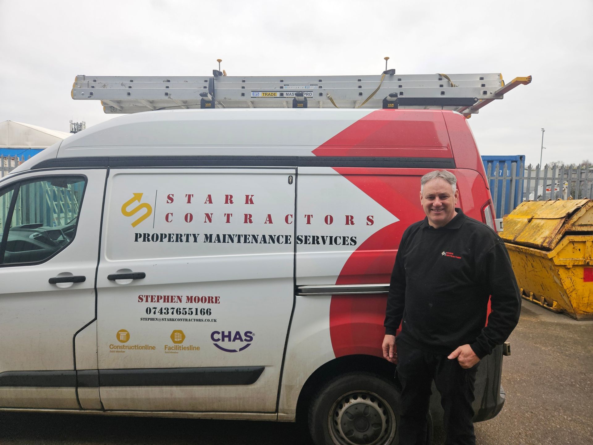 Picture of Nigel in front of the Stark Contractors Van