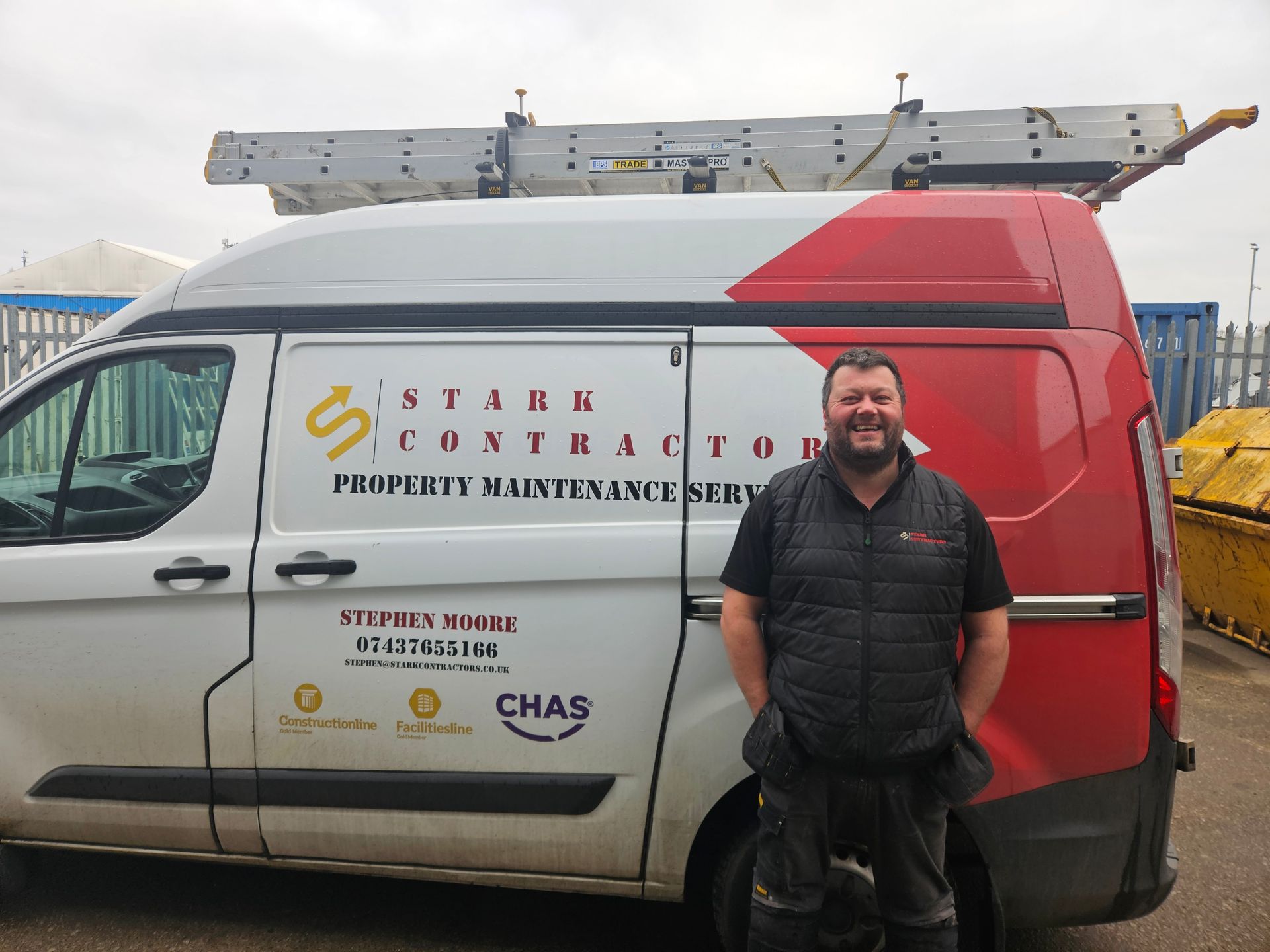 Picture of Stuart in front of the Stark Contractors Van