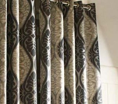 Patterned curtains with dark and light tones, featuring decorative leaf-like designs