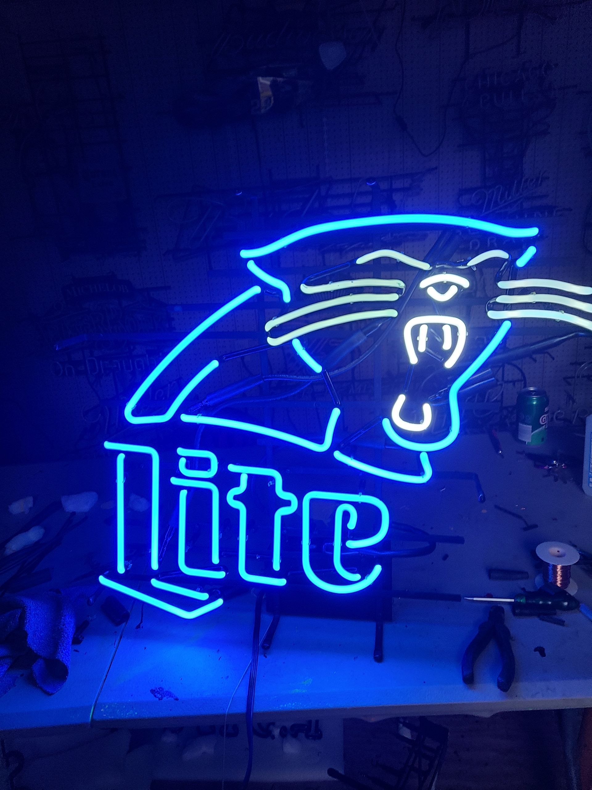 Neon sign, Miller Lite logo with panther in blue and white.