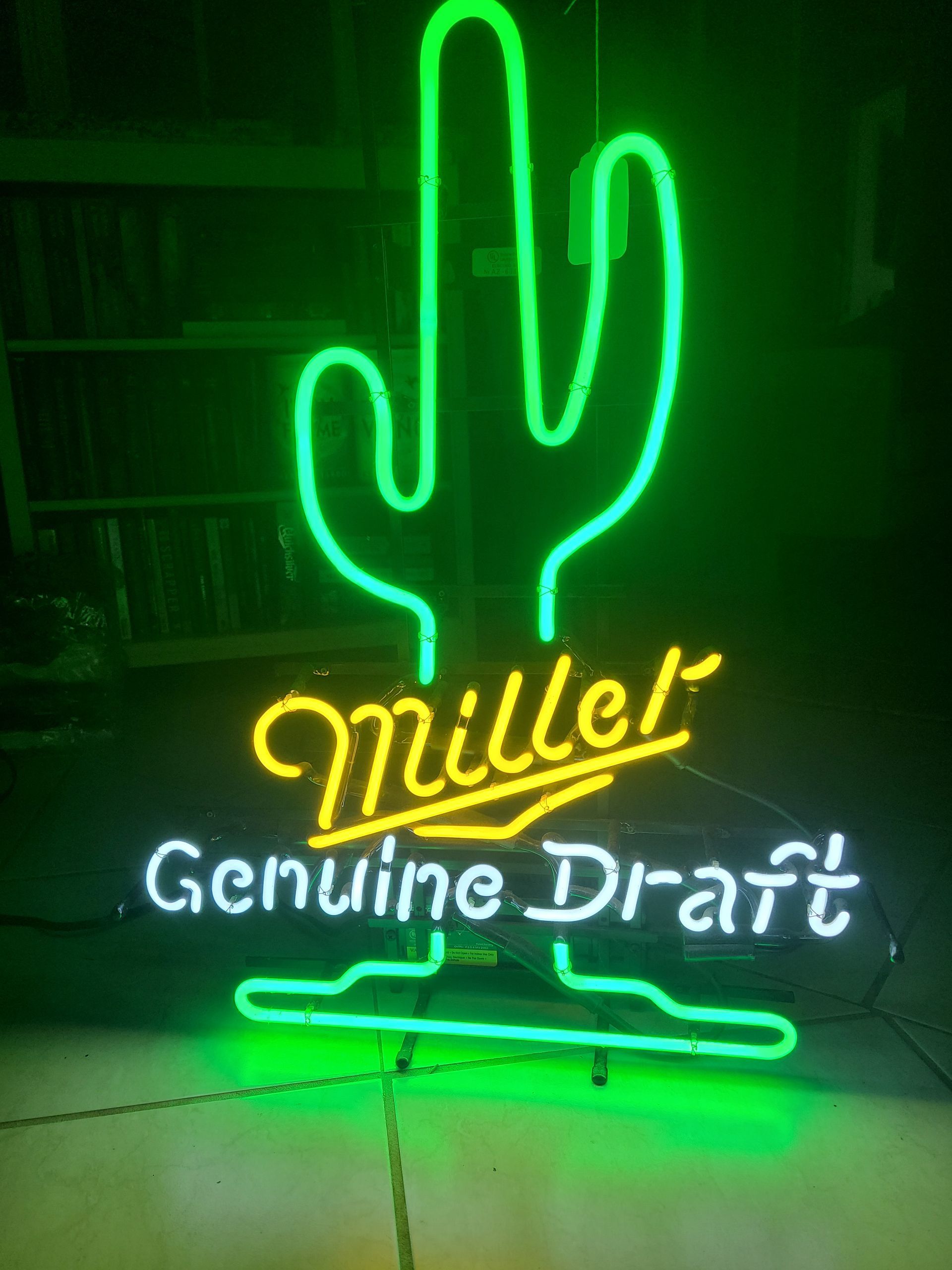 Neon sign: Green cactus, Miller Genuine Draft in yellow and white, black background.