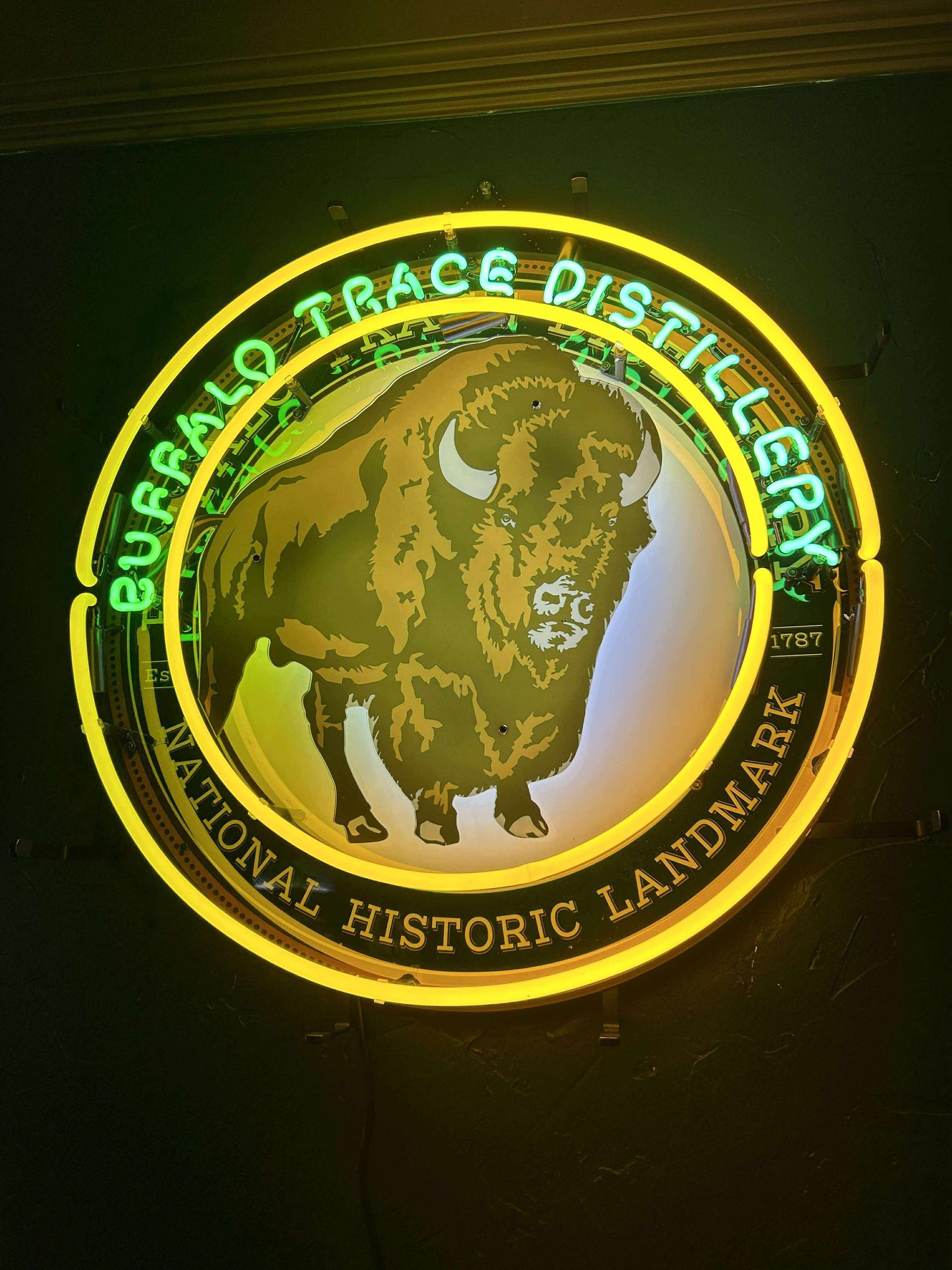 Neon sign of Buffalo Trace Distillery, featuring a bison illustration, and text 