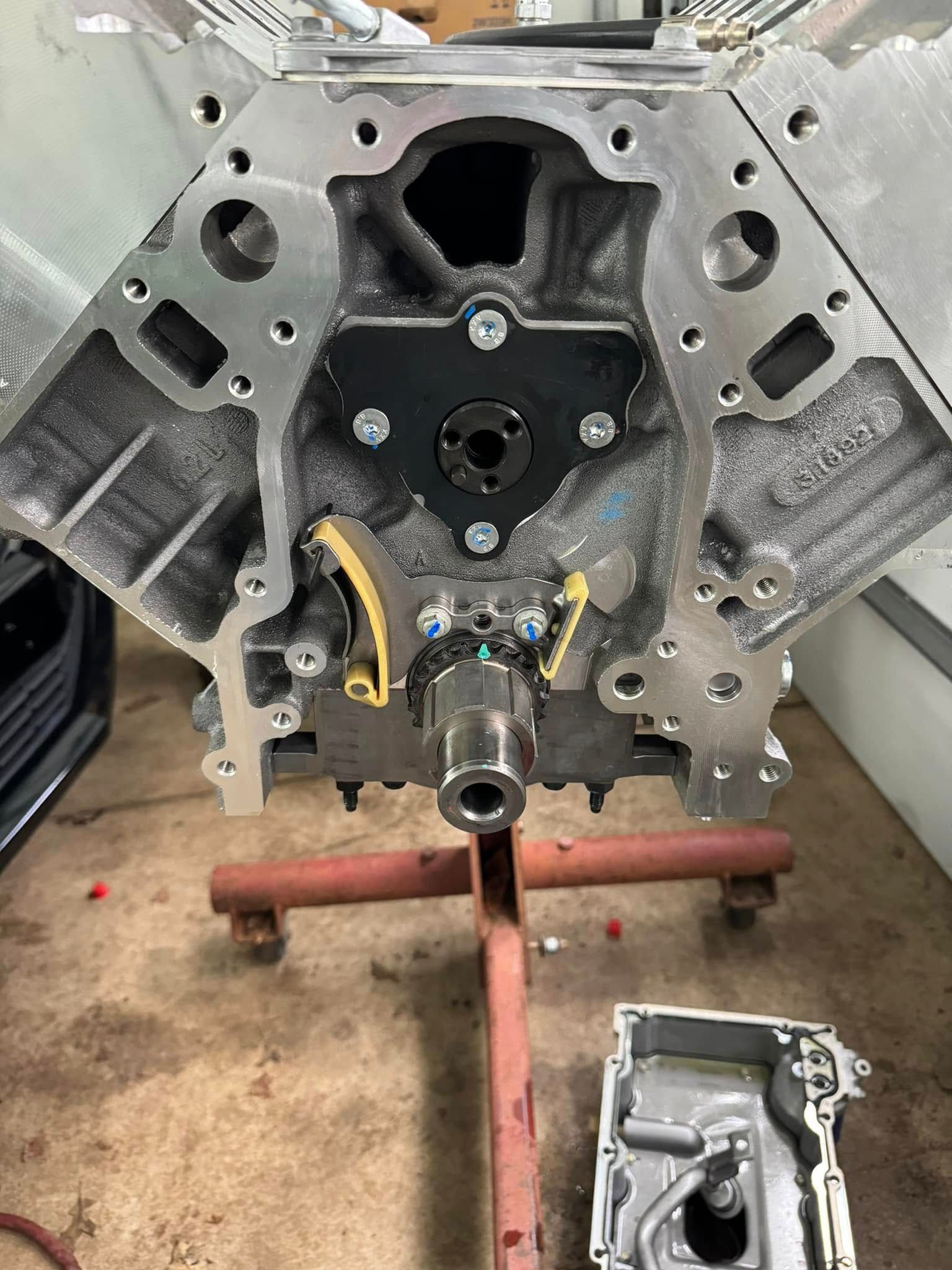 A close up of a car engine on a stand.