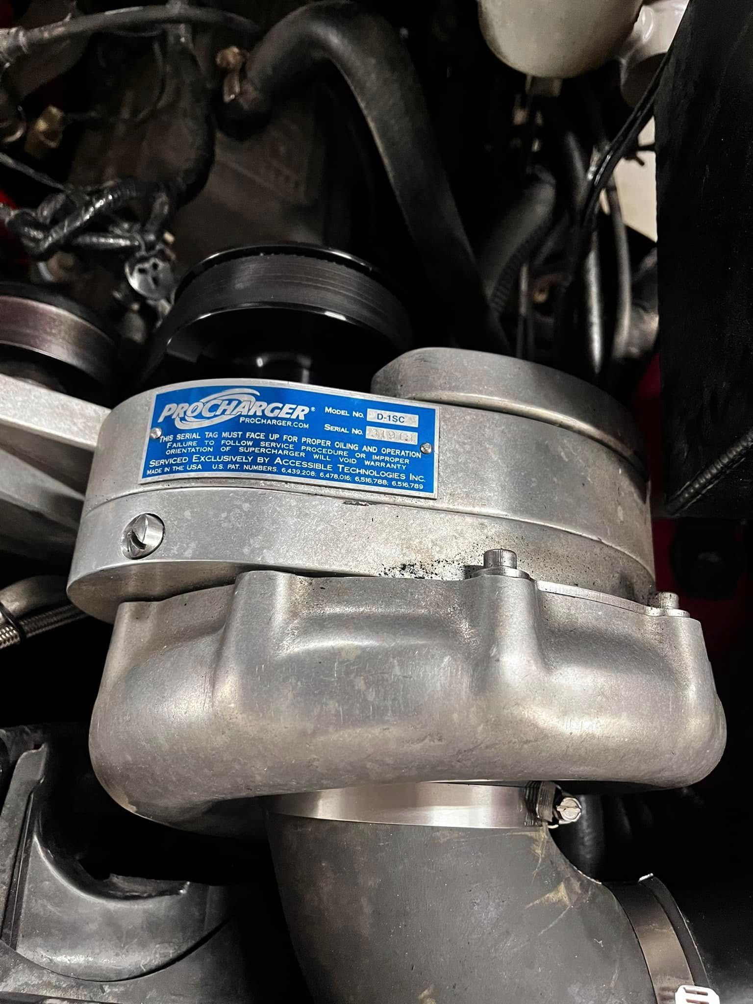 A close up of a turbocharger in a car engine.