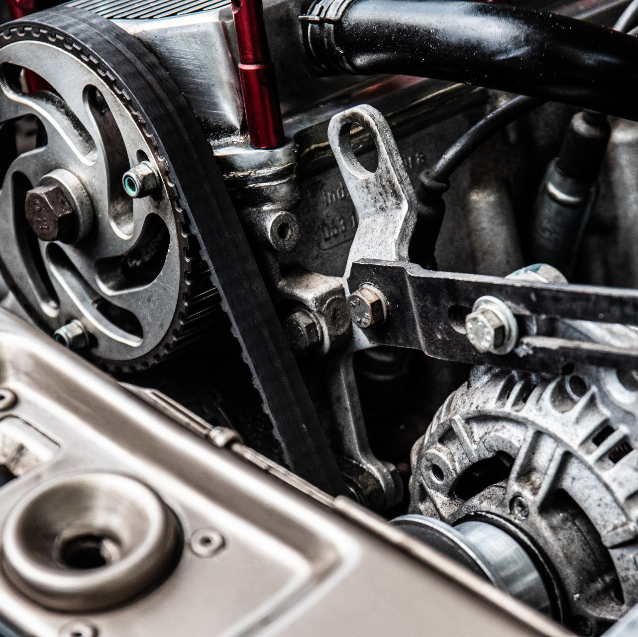 A close up of a car engine with the hood open