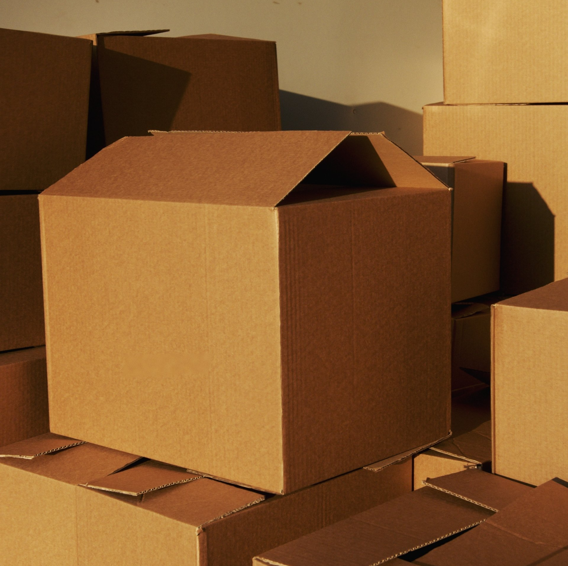 A stack of cardboard boxes with one being empty
