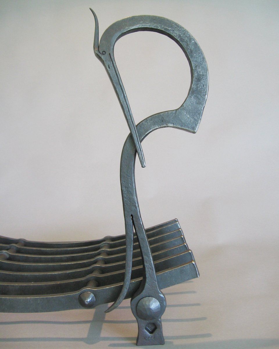 hand forged fireplace woodrack heron detail