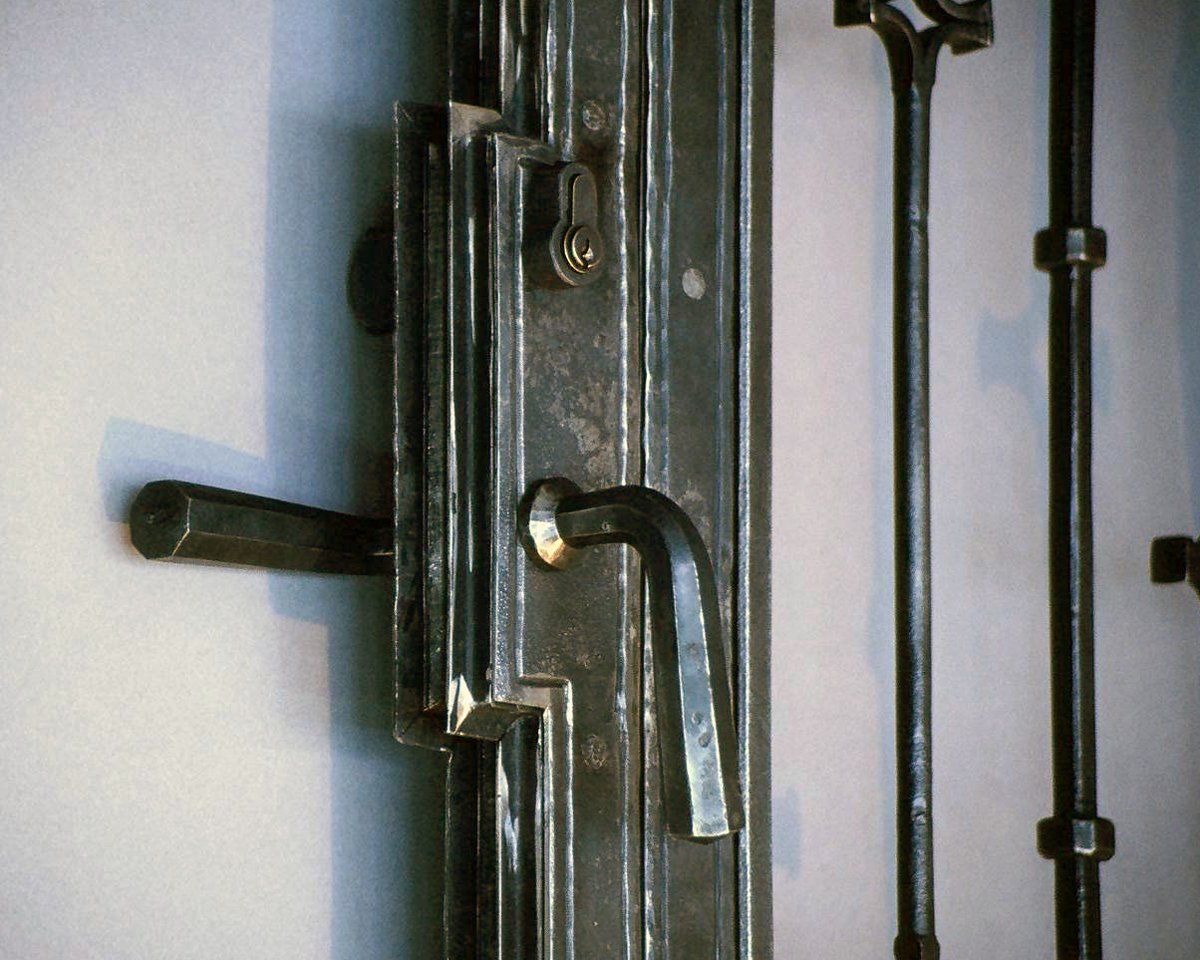 designer hand forged ironwork wine cellar entry latch detail
