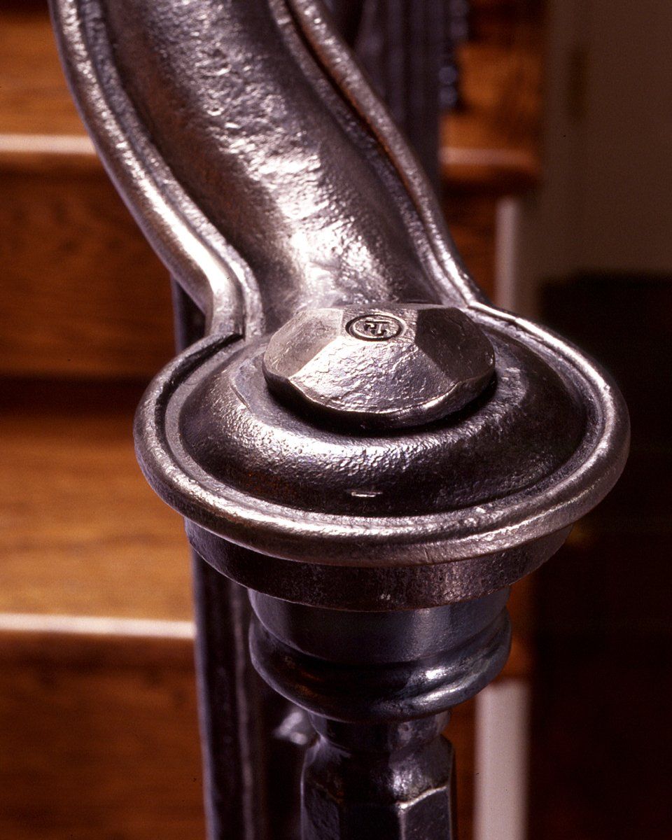 custom forged iron stairwell banister detail