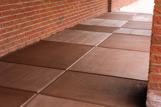A group of construction workers are working on a concrete slab.