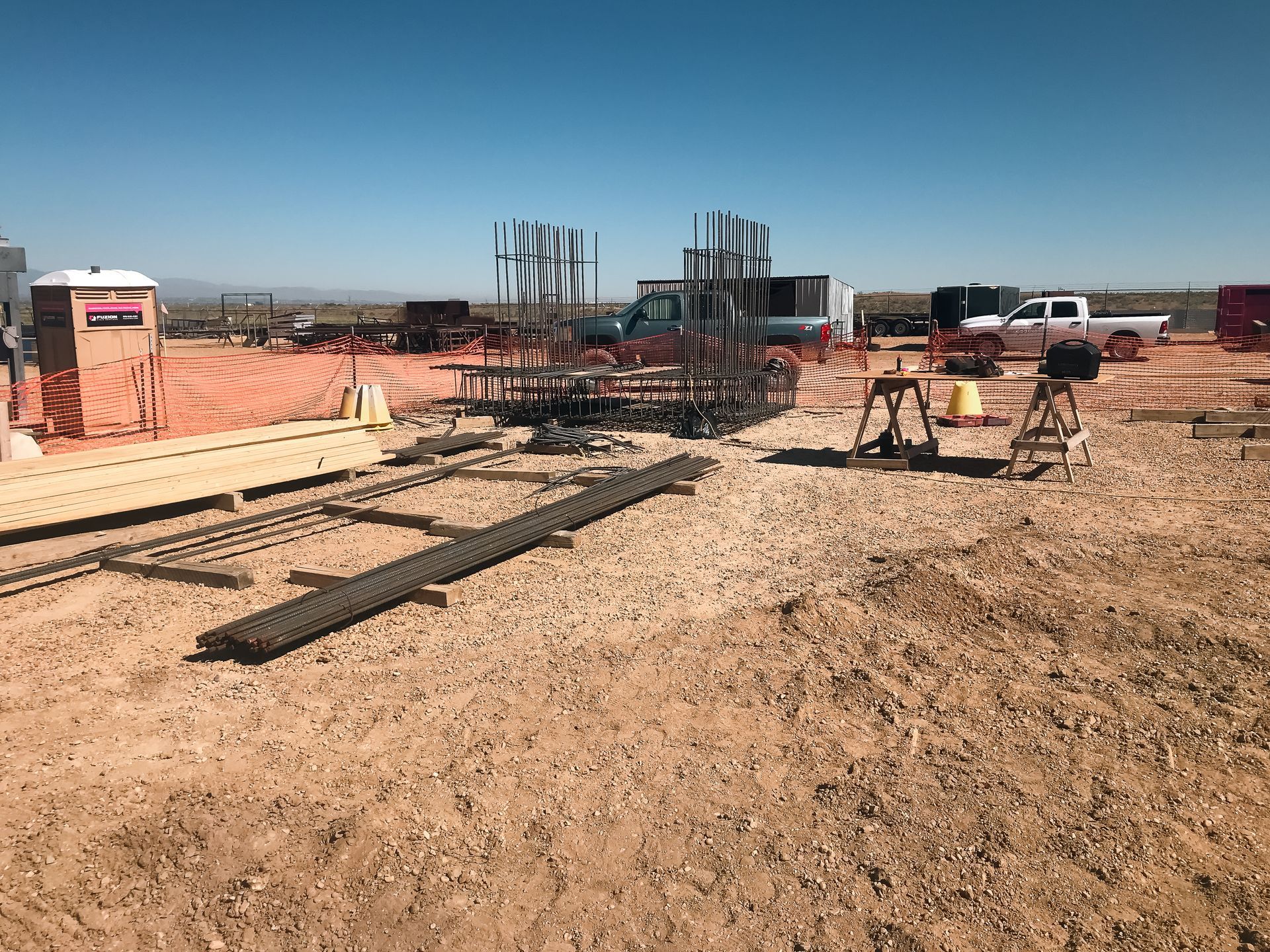 A construction site in the desert with a lot of wood and metal.