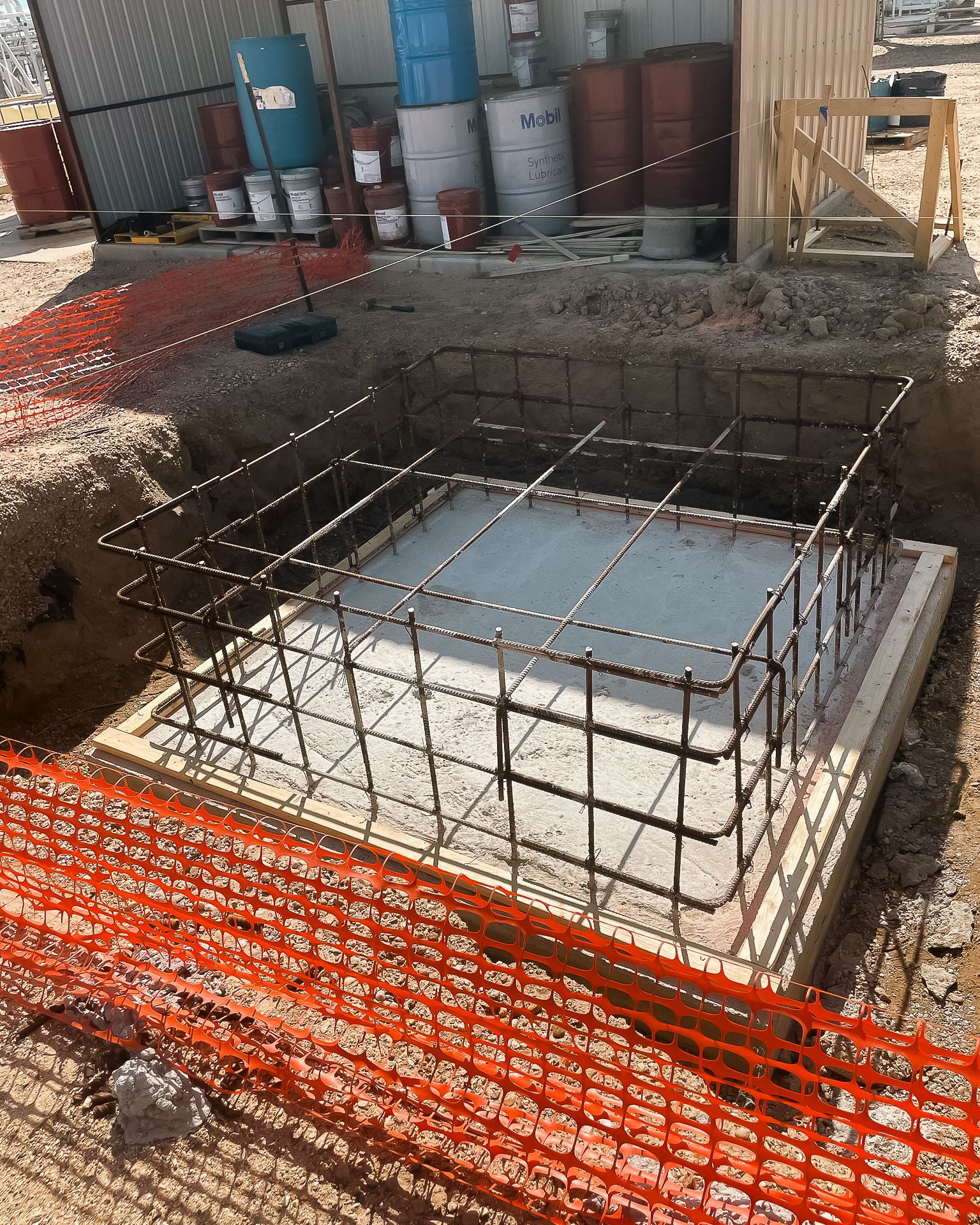 A large hole in the ground with a fence around it.
