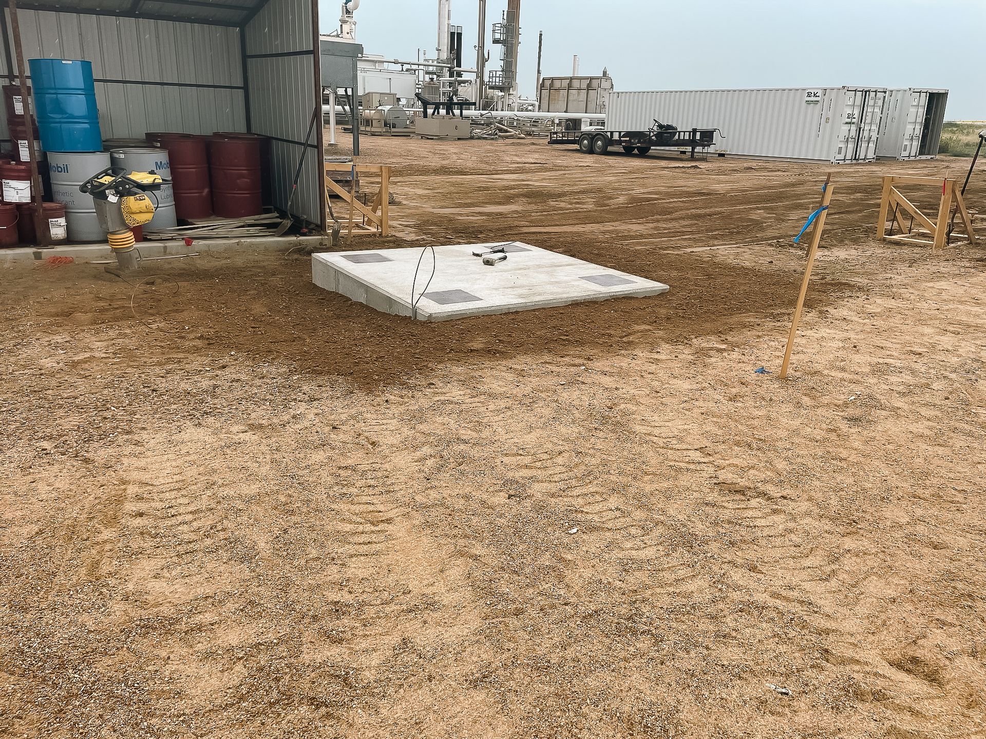 A large field with a concrete slab in the middle of it.