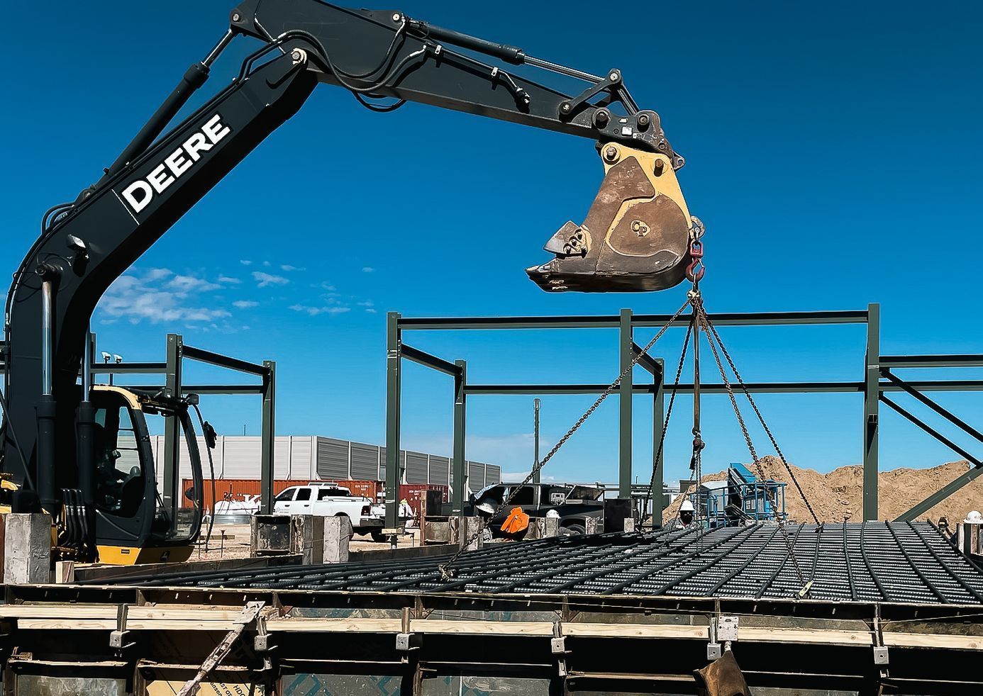 A deere excavator is working on a construction site