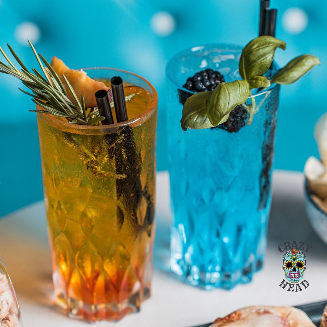 Un bicchiere blu con cannucce e un bicchiere giallo con cannucce