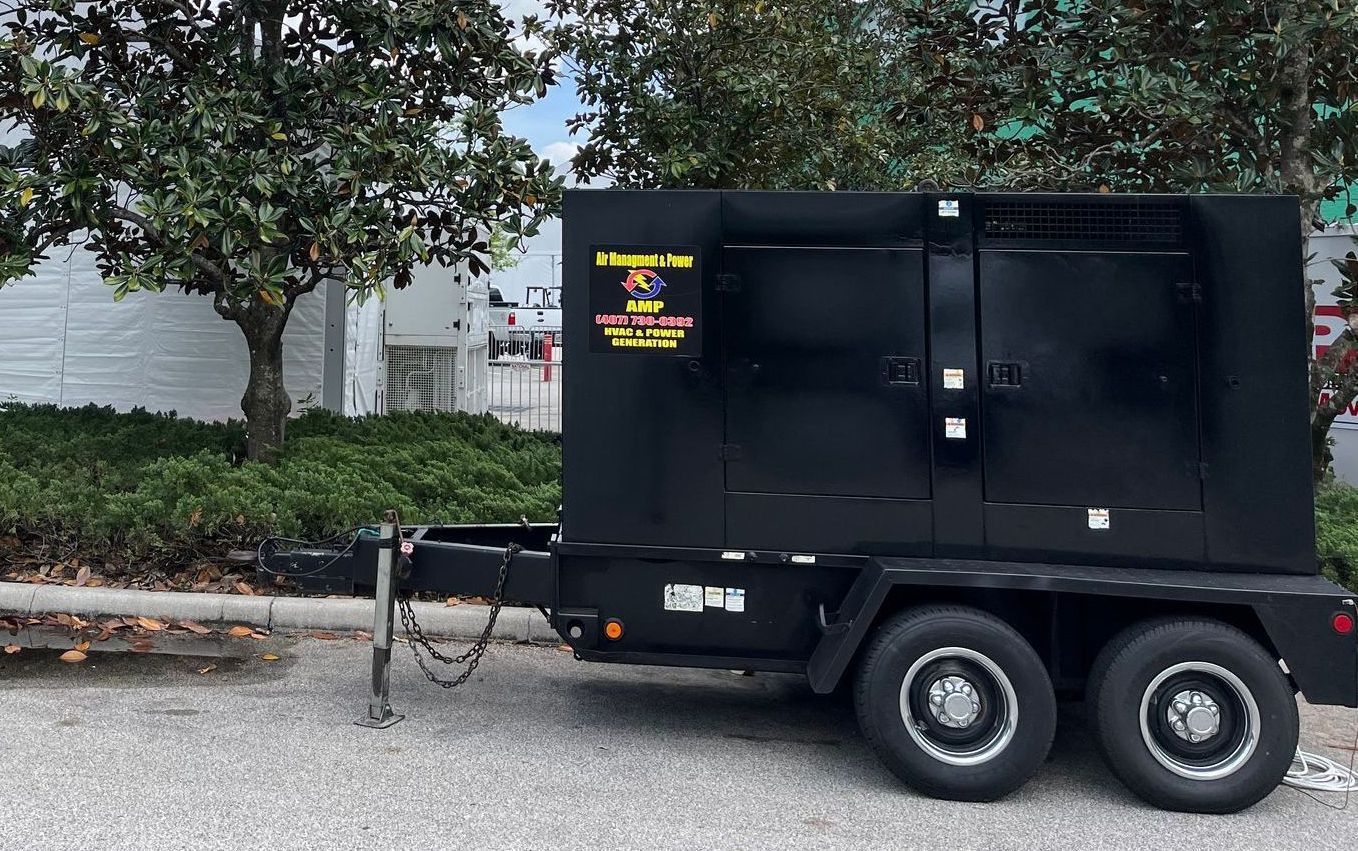 A black trailer is parked on the side of the road.