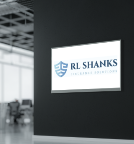 RL Shanks Insurance Solutions sign on a dark wall in a modern office lobby