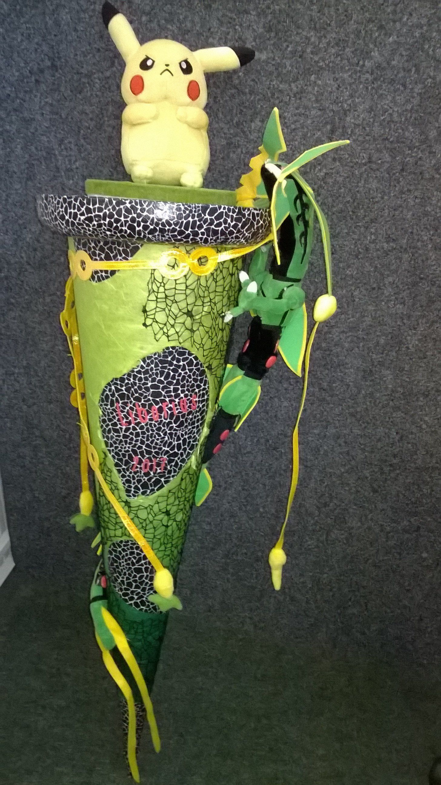 Ein ausgestopftes Pikachu sitzt auf einem grünen Kegel