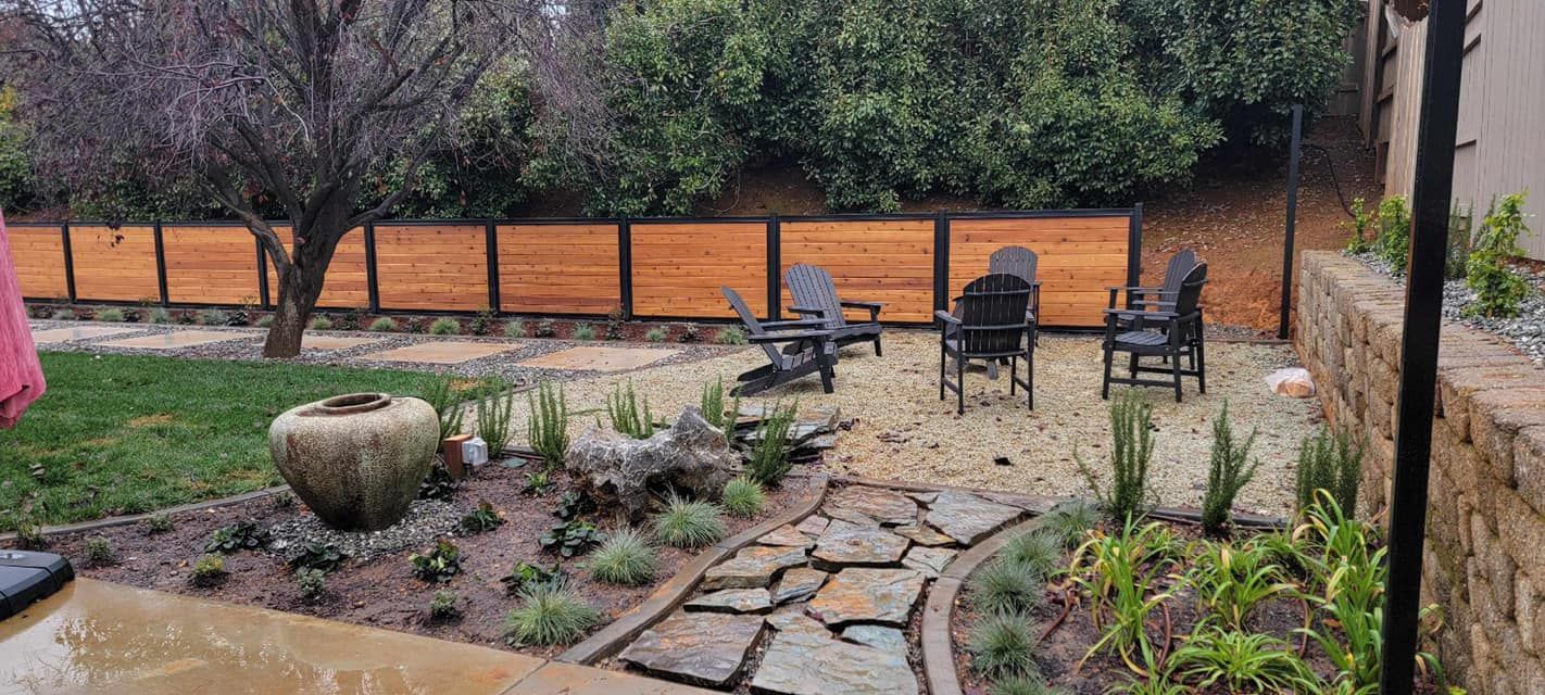 A Backyard With A Wooden Fence, Chairs, and Umbrellas | Redding, CA | Chase Design Landscape