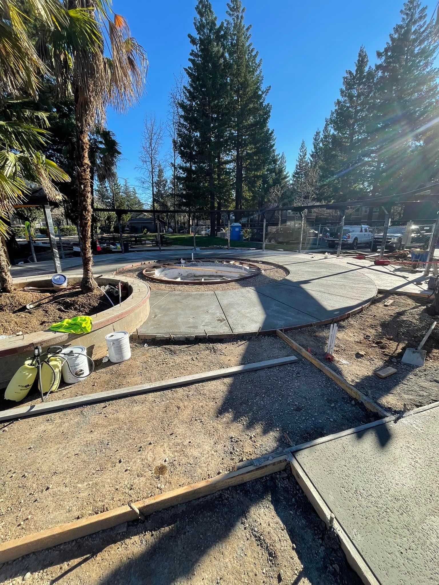 A Concrete Walkway Is Being Built in A Park with Trees in The Background | Redding, CA | Chase Design Landscape