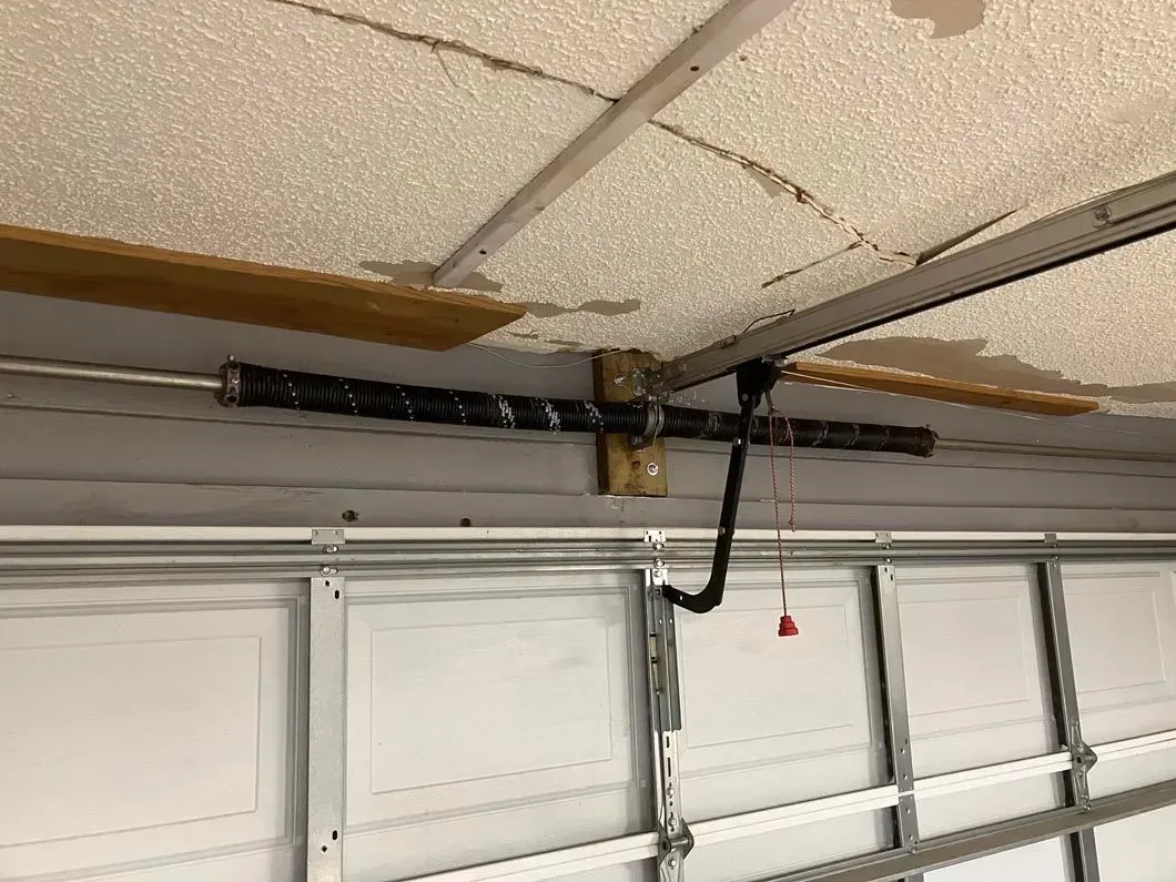 garage door spring replacement apopka fl Garage door opener system with a broken spring, mounted on the ceiling.