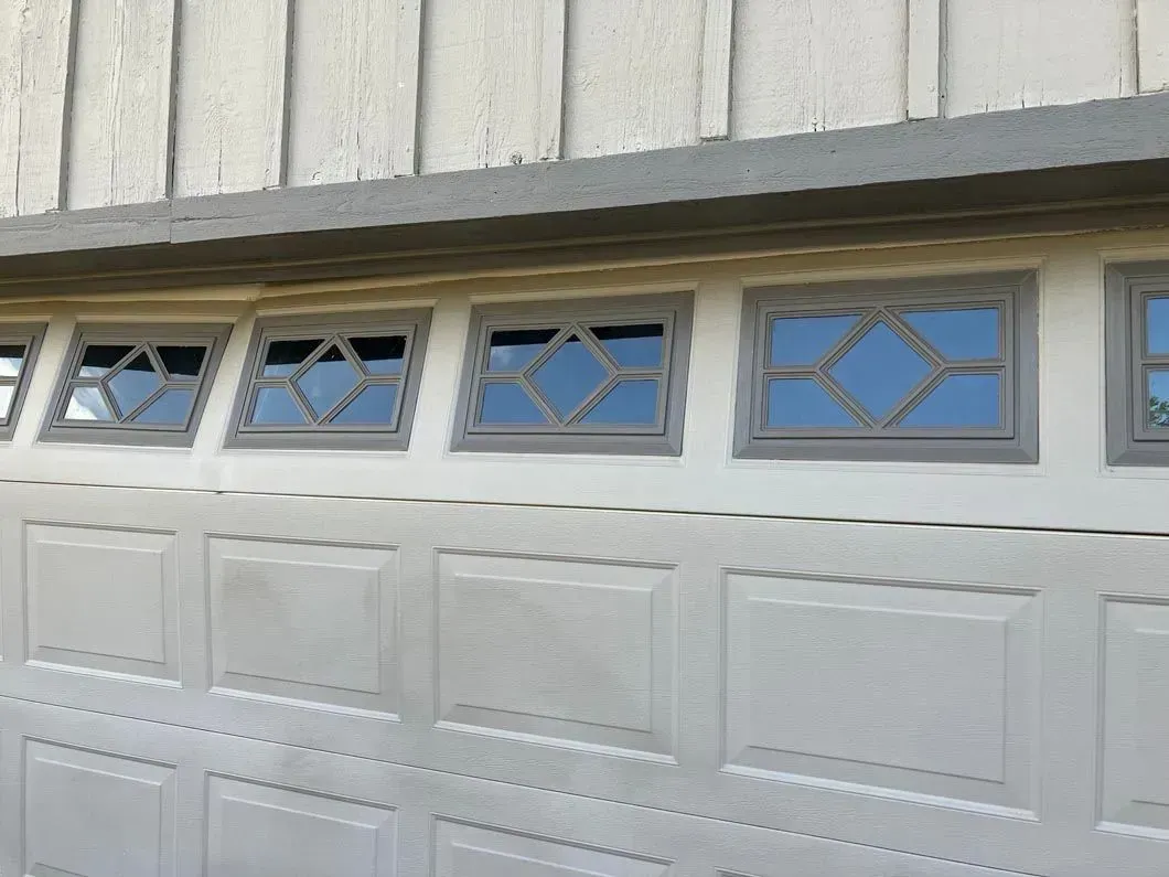 garage door spring replacement apopka fl Garage door with decorative windows. Beige door panels, gray trim, with geometric window panes.