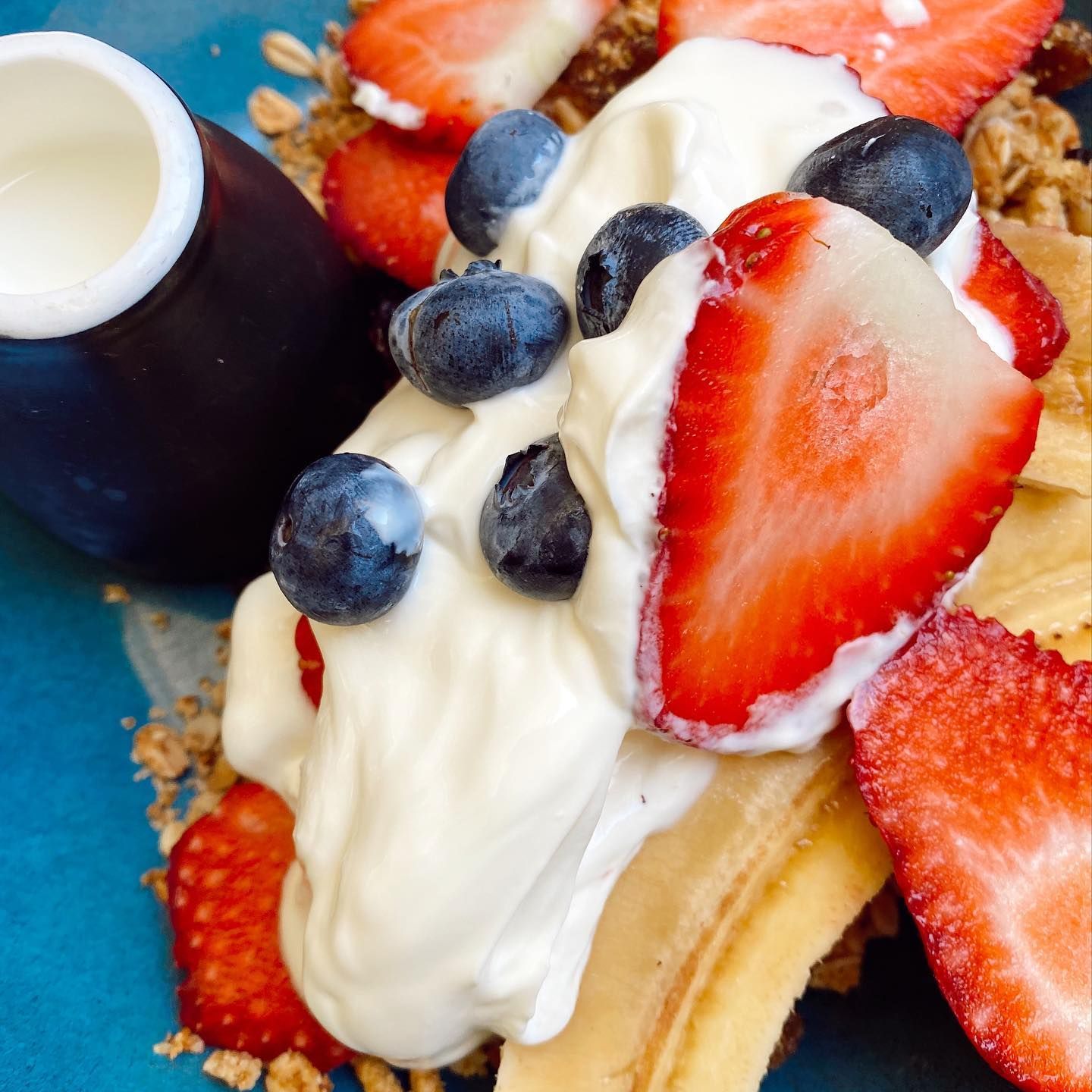 A Close Up of a Dessert With Strawberries Blueberries and Whipped Cream — The Pass Cafe in Byron Bay, NSW