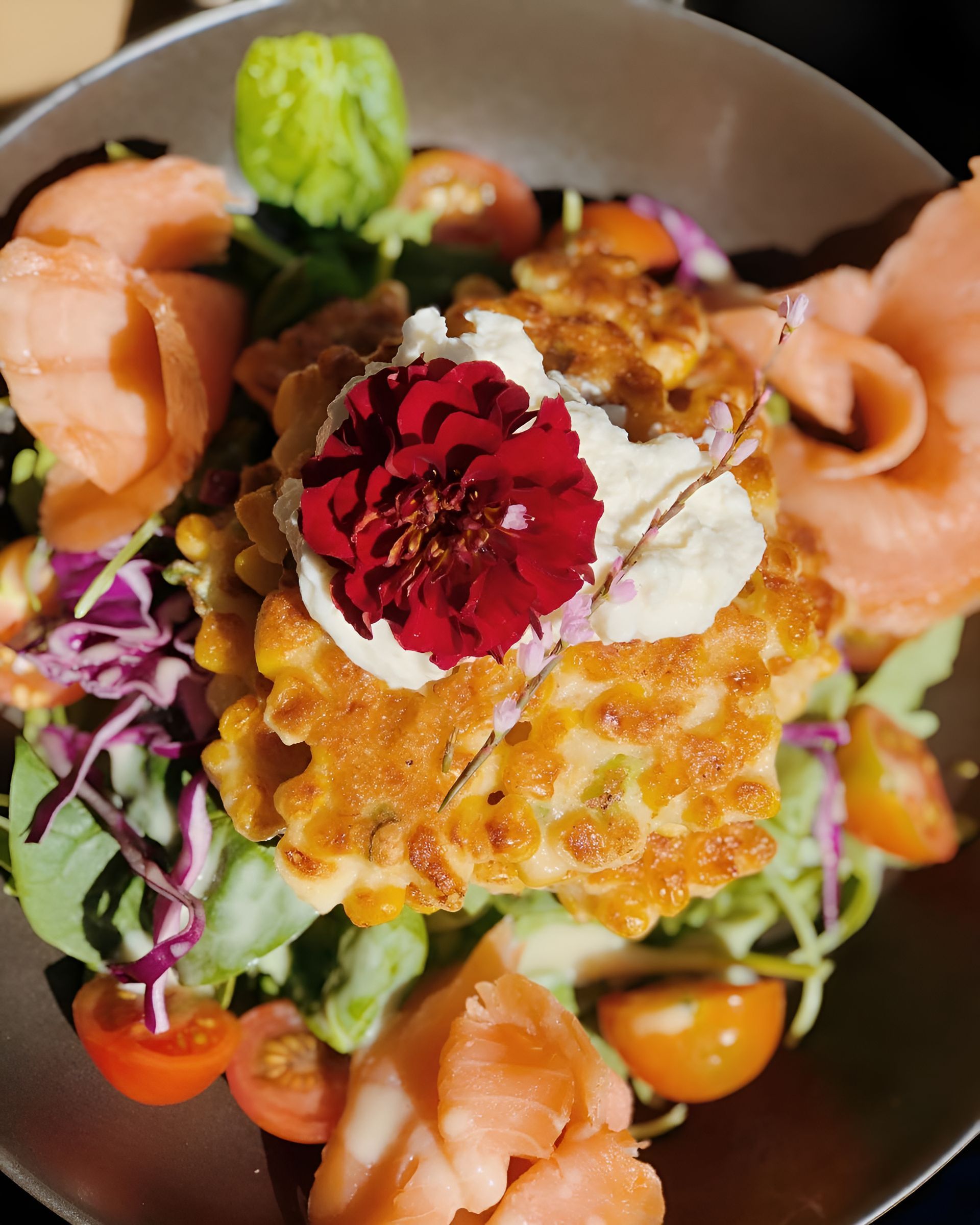 A Close Up of a Plate of Food With a Flower on Top — The Pass Cafe In Byron Bay, NSW