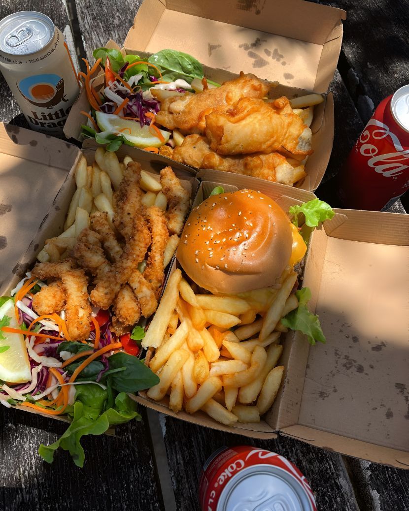 A Hamburger and French Fries Are in a Cardboard Box on a Table — The Pass Cafe In Byron Bay, NSW