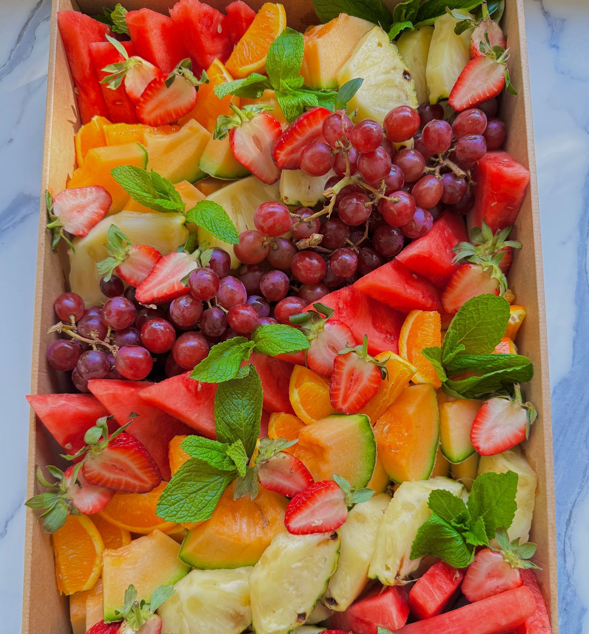 A box filled with a variety of fruits and vegetables — The Pass Cafe in Byron Bay, NSW