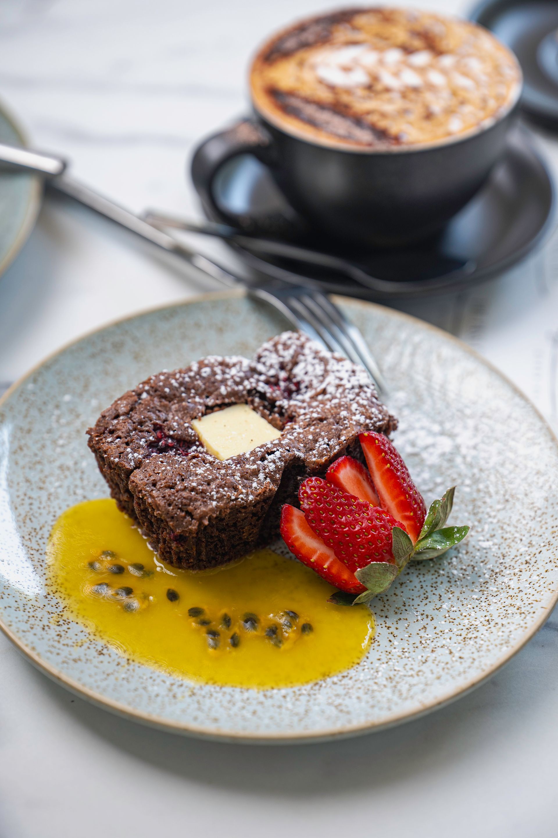 A Close Up of a Plate of Food With Strawberries and a Cup of Coffee — The Pass Cafe In Byron Bay, NSW