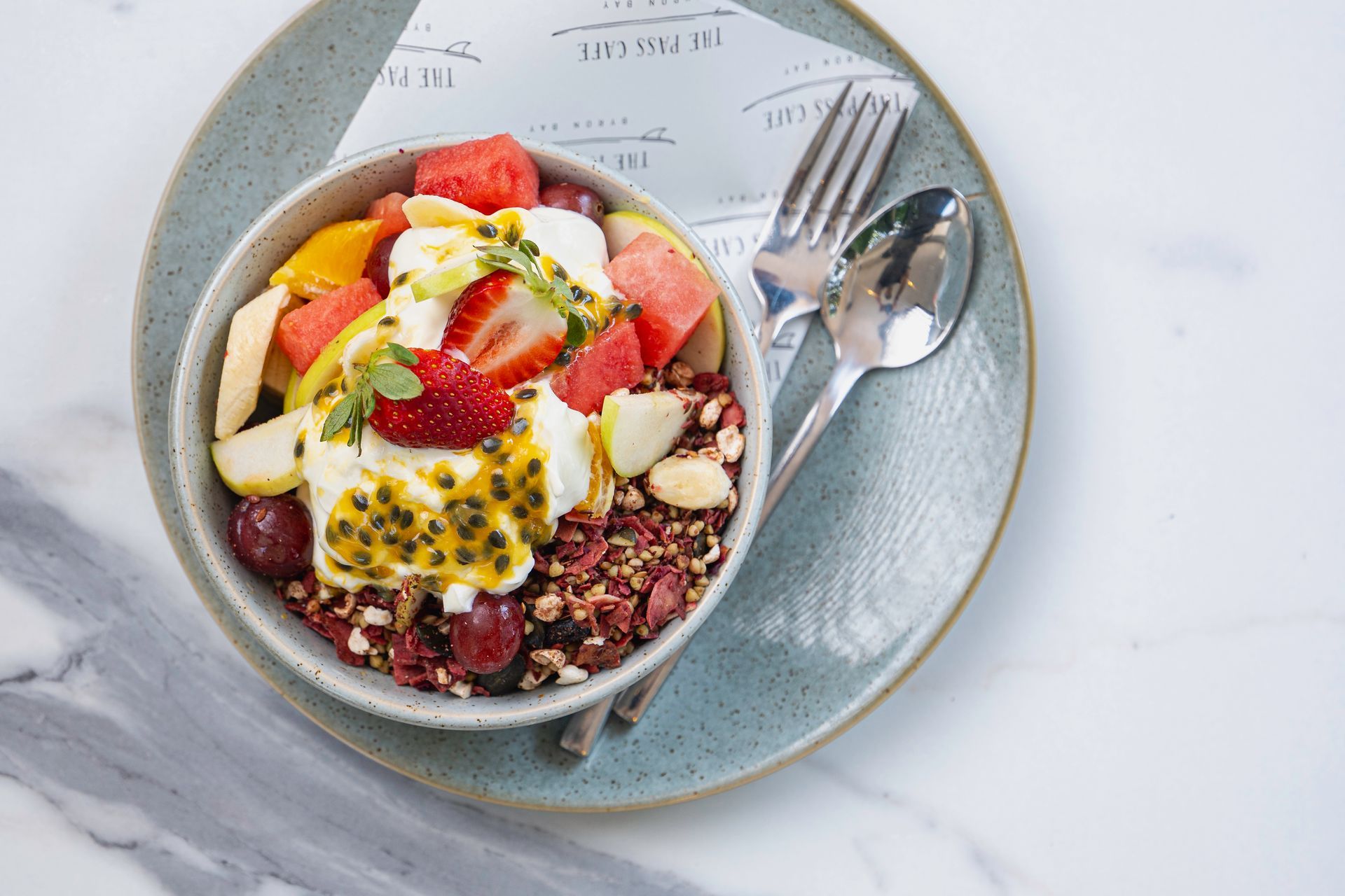 A Bowl of Fruit and Granola on a Plate With a Fork — The Pass Cafe In Byron Bay, NSW