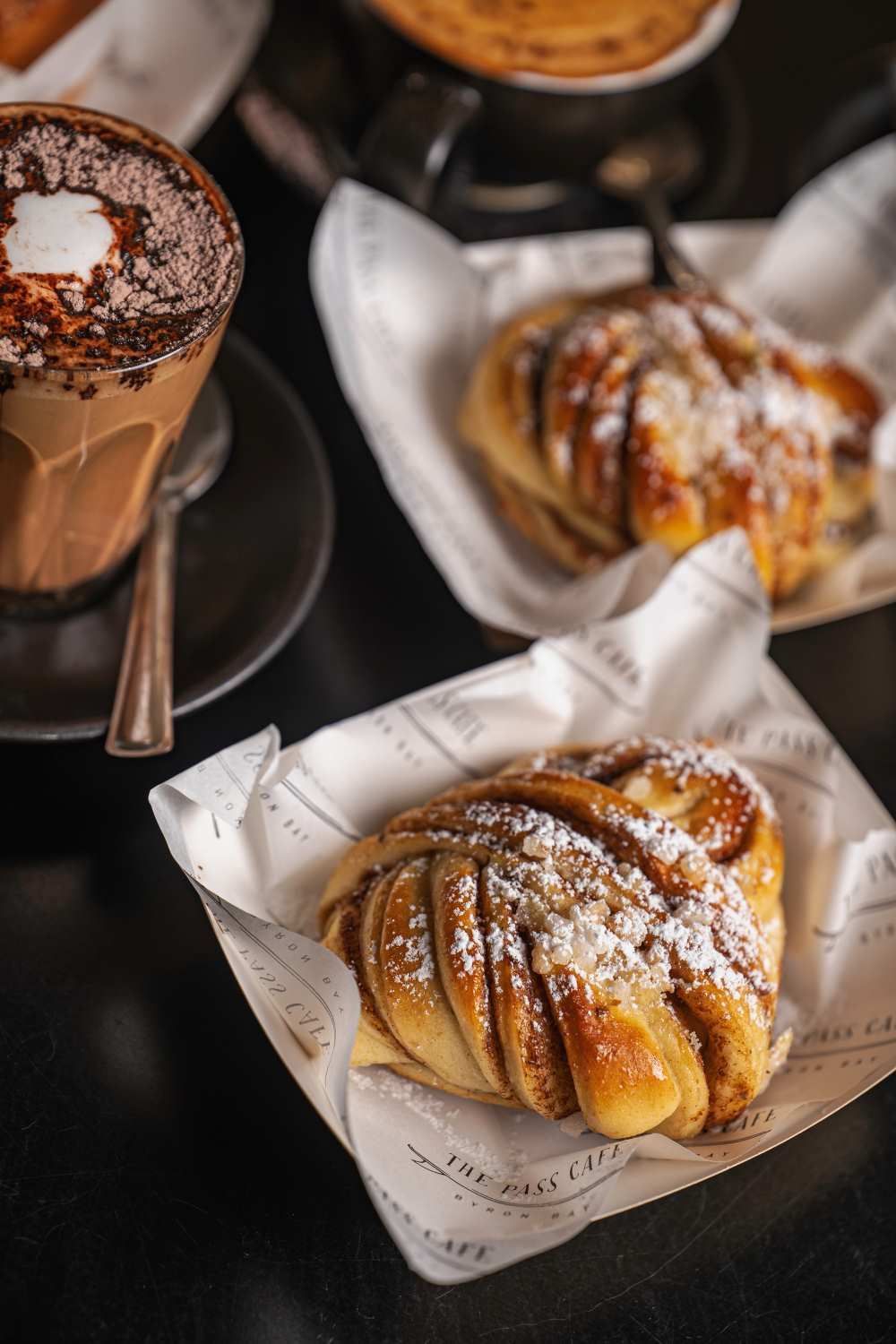 A Bunch of Pastries and a Cup of Coffee on a Table — The Pass Cafe in Byron Bay, NSW
