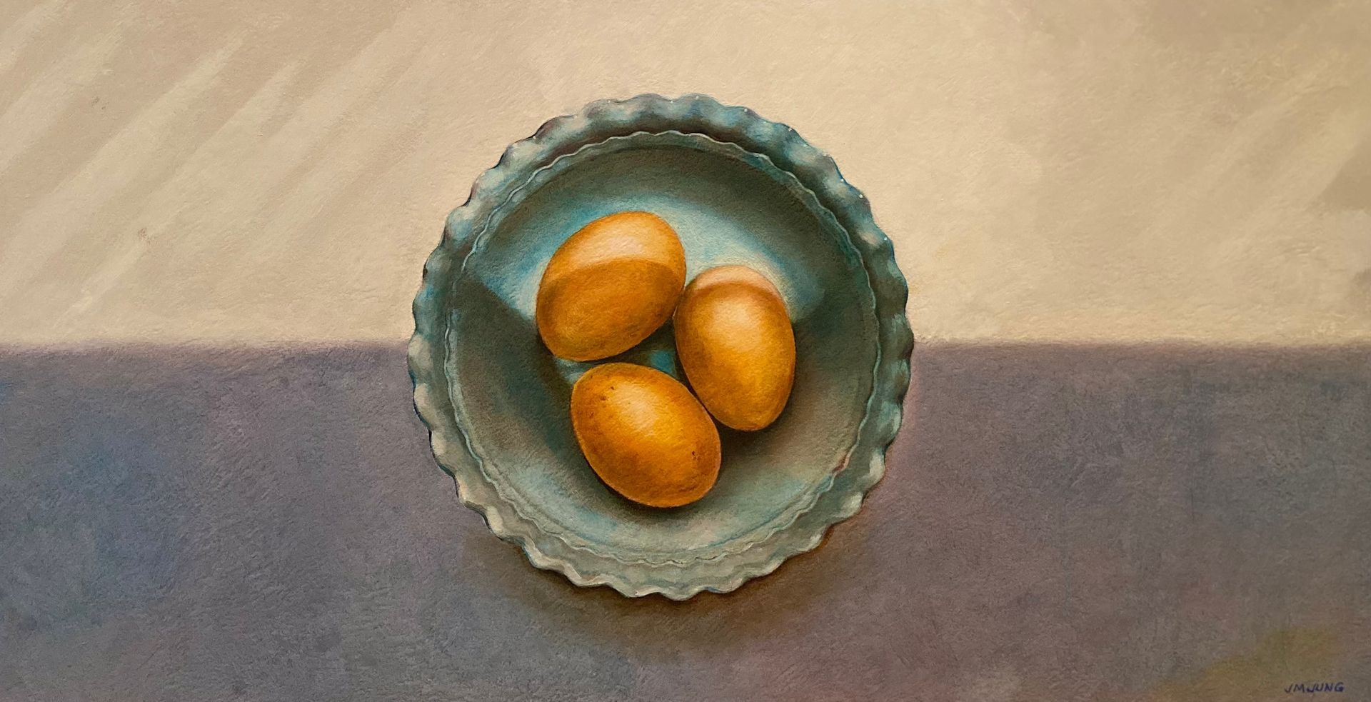 Three brown eggs in a blue bowl sitting on a windowsill with light from Venetian blinds falling over it.