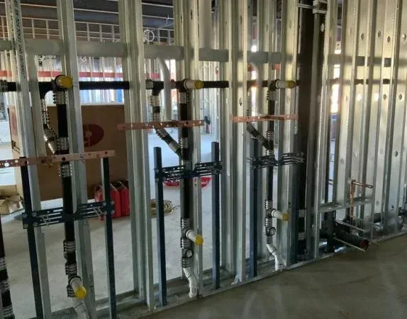 A wall with a lot of pipes