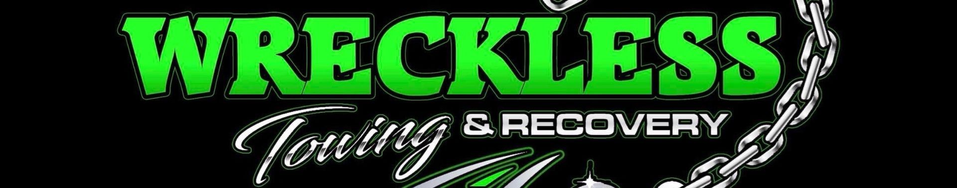 A green and white logo for wreckless wrestling and recovery