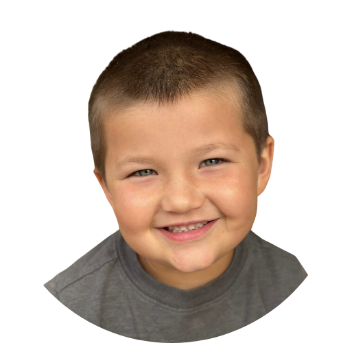 A young boy with braces on his teeth smiles for the camera