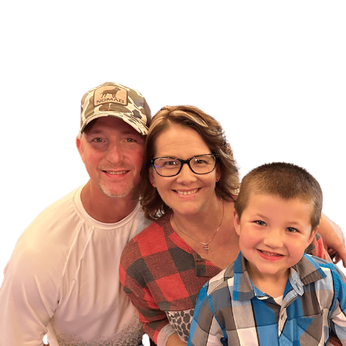 A man , woman and child are posing for a picture.