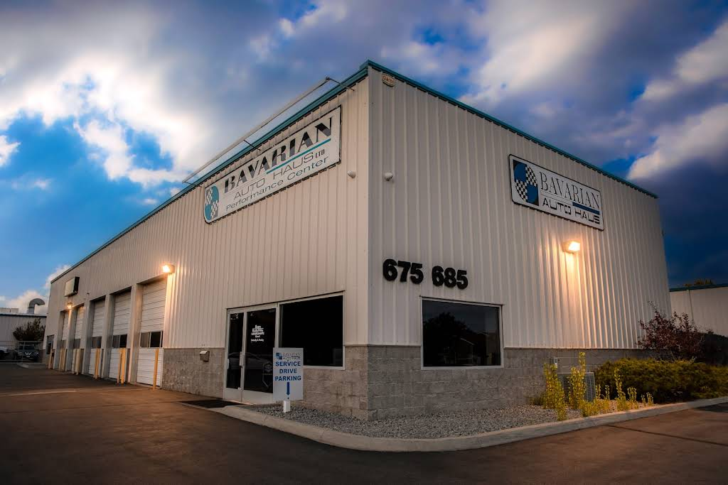 Industrial building with metal siding and sign, numbers 675 and 685, under cloudy sky. | Bavarian Auto Haus